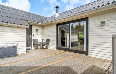 a large sliding glass door on a house with a deck at Awesome Home In Vemb With Kitchen in Vemb