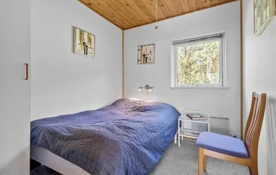 a bedroom with a bed and a chair and a window at Awesome Home In Vemb With Kitchen in Vemb