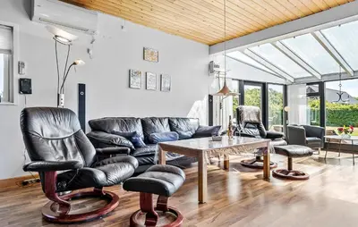 a living room with leather chairs and a table at Awesome Home In Vemb With Kitchen in Vemb