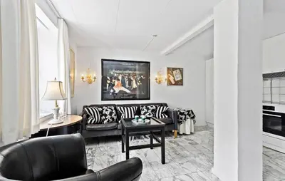 a living room with a couch and a table at Lejl 4 in Brovst
