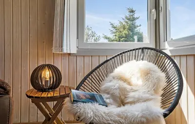 a dog sitting in a chair with a book at Lovely Home In Thisted With Kitchen in Thisted