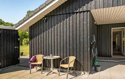 a patio with a table and chairs on a building at Pet Friendly Home In Farsø With Kitchen in Farsø