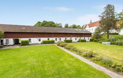 an exterior view of a barn with a large yard at Lejl 3 in Brovst