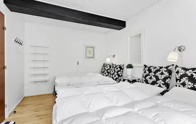 a white room with two beds and a couch at Lejl 1 in Brovst