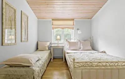 a bedroom with two beds and a window at Hus 1 in Brovst