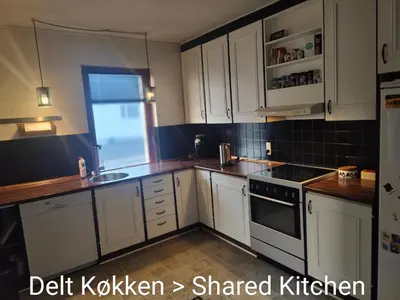 a kitchen with white cabinets and a sink at Billig overnatning tæt på badestrand og jesperhus in Roslev