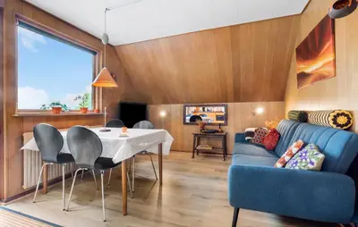 a living room with a table and a blue couch at Lovely Apartment In Erslev With Wifi in Erslev