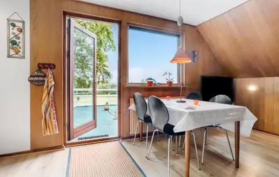 a dining room with a table and chairs and a large window at Lovely Apartment In Erslev With Wifi in Erslev