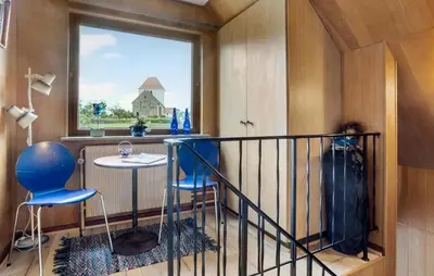 a balcony with blue chairs and a table and a window at Lovely Apartment In Erslev With Wifi in Erslev