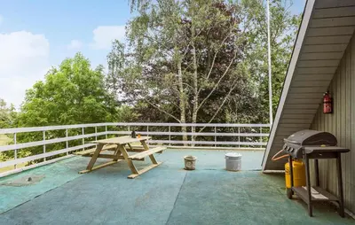 a picnic table on the back porch of a house at Lovely Apartment In Erslev With Wifi in Erslev