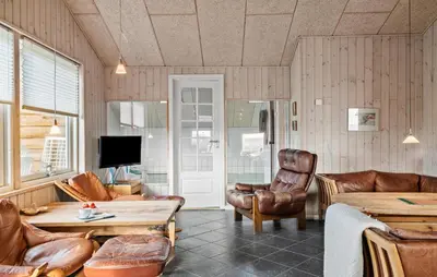 a living room with leather chairs and a table at Gorgeous Home In Harboøre With Kitchen in Harboør