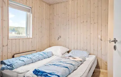 a bed in a room with a window at Gorgeous Home In Harboøre With Kitchen in Harboør