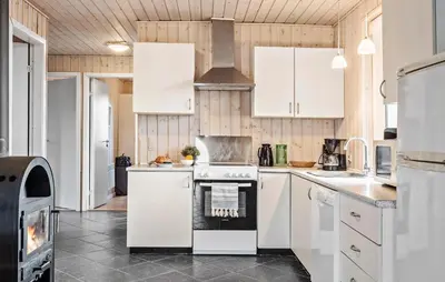 a kitchen with white cabinets and an oven at Gorgeous Home In Harboøre With Kitchen in Harboør