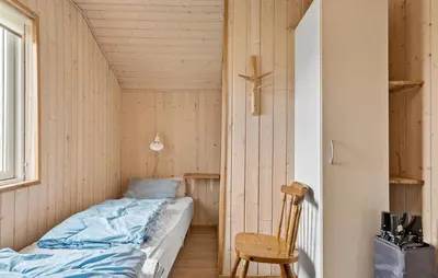a small bedroom with a bed in a small room at Nice Home In Harboøre With Kitchen in Harboør