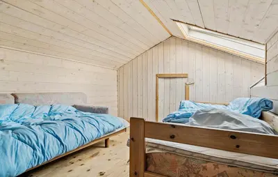 a bedroom with two beds and a skylight at Nice Home In Harboøre With Kitchen in Harboør