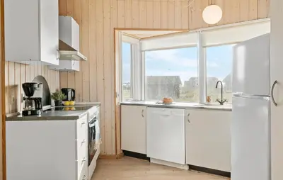 a kitchen with white appliances and a window at Nice Home In Harboøre With Kitchen in Harboør