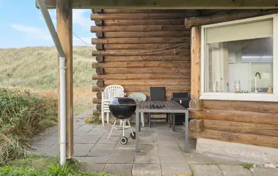 a grill and a table outside of a cabin at Nice Home In Harboøre With Kitchen in Harboør