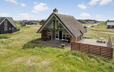 a small house with a roof on a field at Cozy Home In Harboøre With Wifi in Harboør