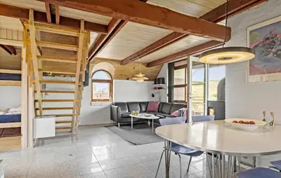 a kitchen and living room with a table and chairs at Cozy Home In Harboøre With Wifi in Harboør
