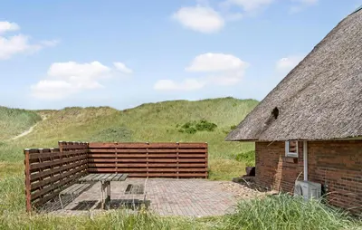 a building with a thatched roof and a patio at Cozy Home In Harboøre With Wifi in Harboør