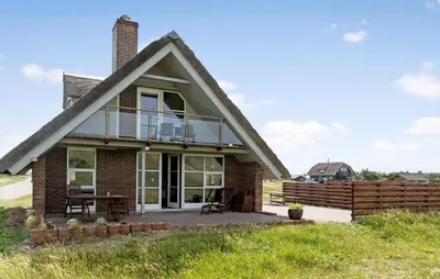 a house with a deck and a patio at Cozy Home In Harboøre With Wifi in Harboør