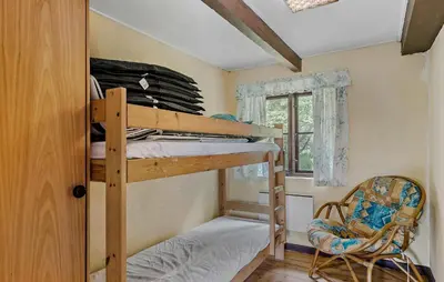 a bedroom with a bunk bed and a chair at 6 Bedroom Gorgeous Home In Bedsted Thy in Bedsted Thy