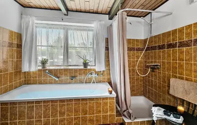 a bathroom with a tub and a window at 6 Bedroom Gorgeous Home In Bedsted Thy in Bedsted Thy