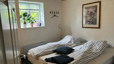 a bed in a bedroom with two pillows on it at Staudeengen et dejlig sted med fred og ro in Ålestrup