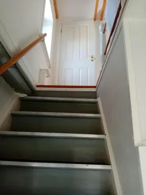 a set of stairs with a white door at Hytten in Frøstrup