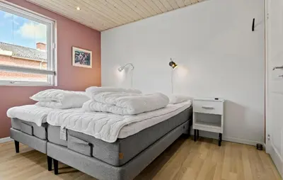 a bedroom with a bed with white sheets on it at Amazing Home In Aars With Wifi in Års