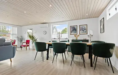 a dining room with a table and green chairs at Amazing Home In Aars With Wifi in Års