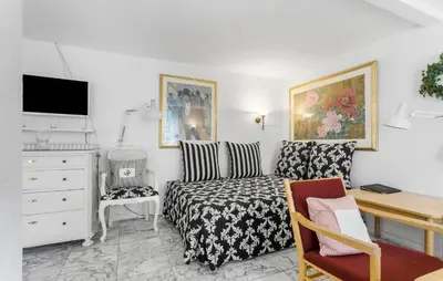 a small bedroom with a bed and a desk at Lejl 6 in Brovst