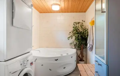a bathroom with a sink and a washing machine at Stunning Home In Brovst With Sauna in Brovst