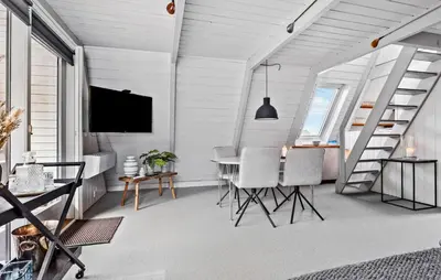 a dining room with a table and chairs and a tv at Nice Home In Farsø With Kitchen in Farsø
