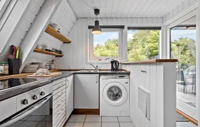 a kitchen with a washing machine and a sink at Nice Home In Farsø With Kitchen in Farsø
