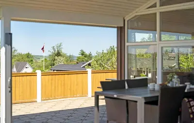 a patio with a table and chairs and a fence at 3 Bedroom Stunning Home In Løgstrup in Løgstrup