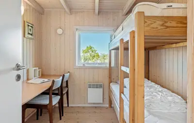 a tiny house with a desk and bunk beds at 3 Bedroom Stunning Home In Løgstrup in Løgstrup