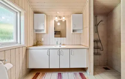 a bathroom with a white sink and a shower at 3 Bedroom Stunning Home In Løgstrup in Løgstrup