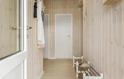 a hallway with wood paneled walls and a door at Awesome Home In Løgstør With Wifi in Løgstør