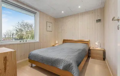 a bedroom with a bed and a large window at Awesome Home In Løgstør With Wifi in Løgstør