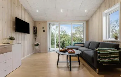 a living room with a couch and a table at Awesome Home In Løgstør With Wifi in Løgstør