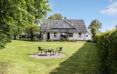 two chairs and a table in front of a house at 3 Bedroom Beautiful Home In Roslev in Roslev