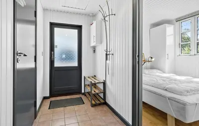 a bedroom with a door leading to a bed at Lovely Home In Vestervig With Kitchen in Vestervig