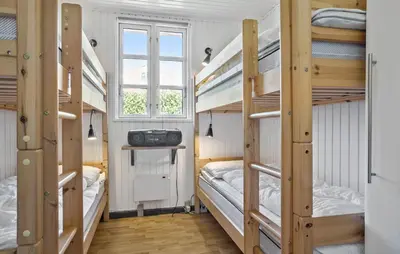 a room with three bunk beds and a window at Lovely Home In Vestervig With Kitchen in Vestervig