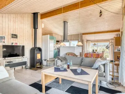 a living room with a couch and a table at Holiday Home Hughe - 200m from the sea by Interhome in Frøstrup