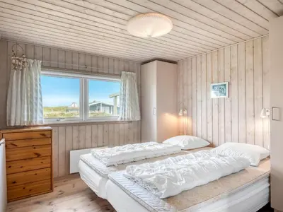 a bedroom with two beds and a window at Holiday Home Hughe - 200m from the sea by Interhome in Frøstrup