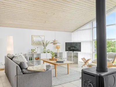 a living room with a couch and a fireplace at Holiday Home Gedda - from the sea by Interhome in Vestervig