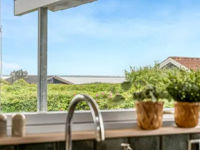 a kitchen window with a sink and plants on a counter at Holiday Home Gedda - from the sea by Interhome in Vestervig