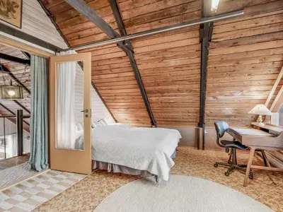 a bedroom with a bed and a desk at Holiday Home Luzy - 75m from the sea by Interhome in Harboør