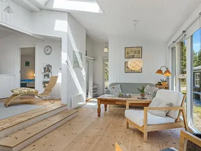 a living room with a couch and a table at Holiday Home Hellena - 700m from the sea by Interhome in Torsted
